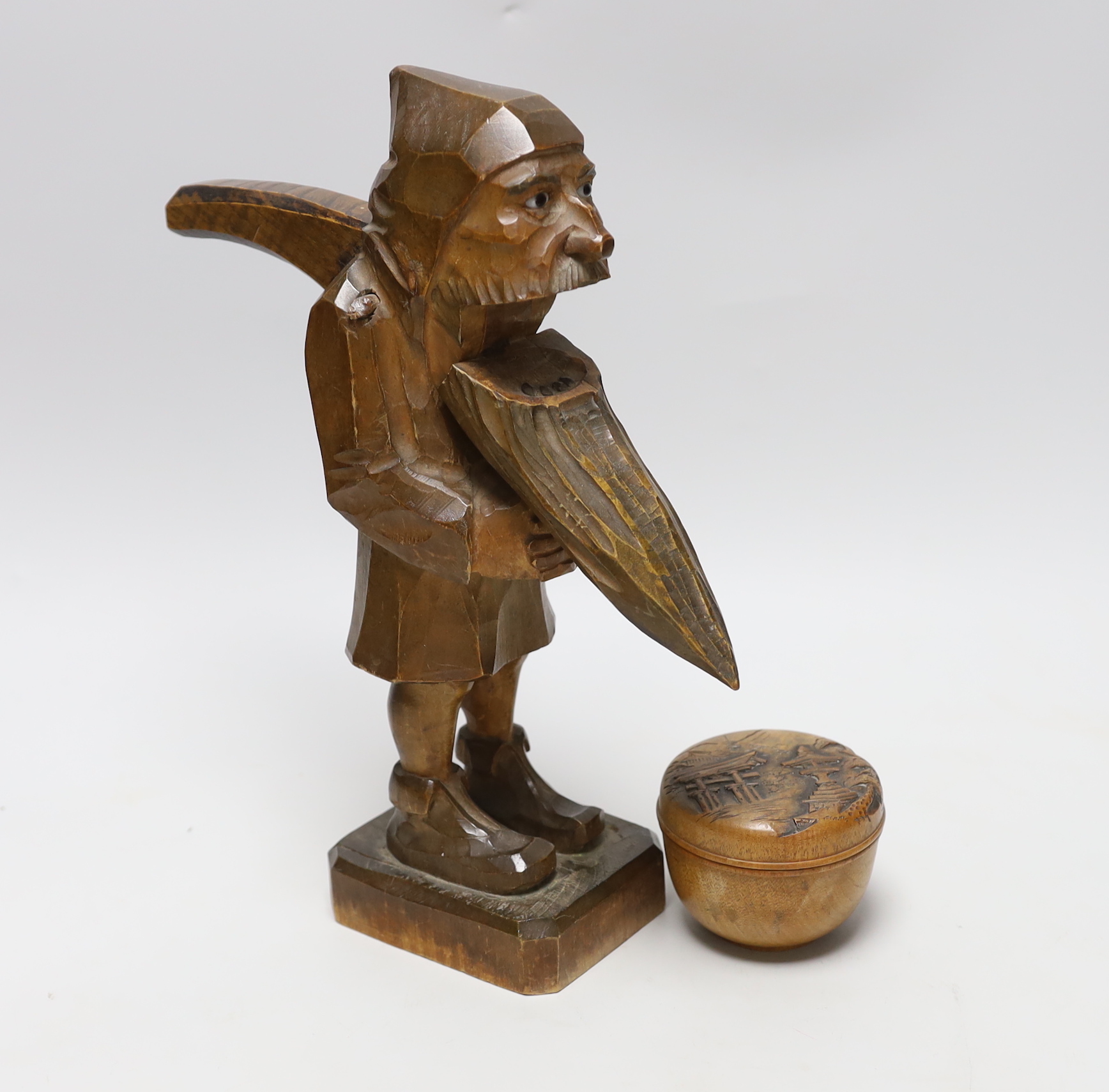 A Black Forest figural nut cracker and a Chinese box and carved cover, 30cm